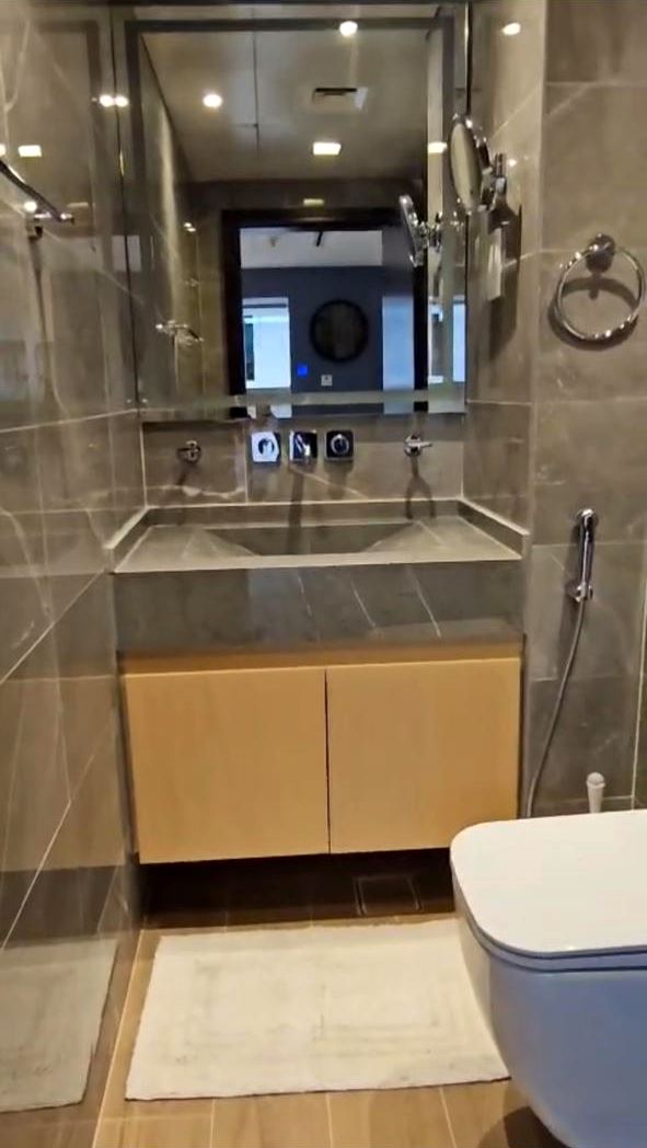 Compact bathroom with stone basin and wall-mounted mixer