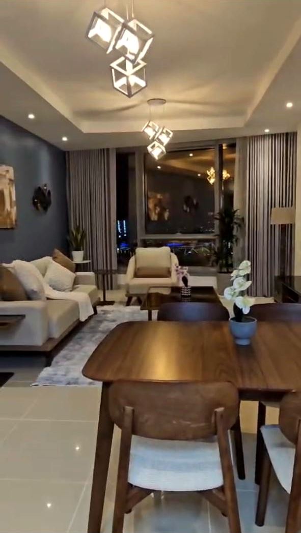 Living and dining area with pendant lights and recessed downlights in a gypsum ceiling